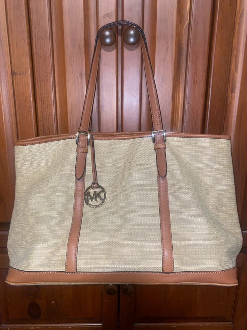 Michael Kors Raffia Tote with Tan Leather Trim and handles.